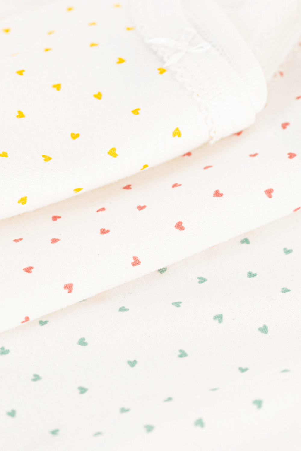 תמונת תקריב של מארז שלושה בגדי גוף קצרים עם לבבות - גילאי 3 חודשים - 36 חודשים