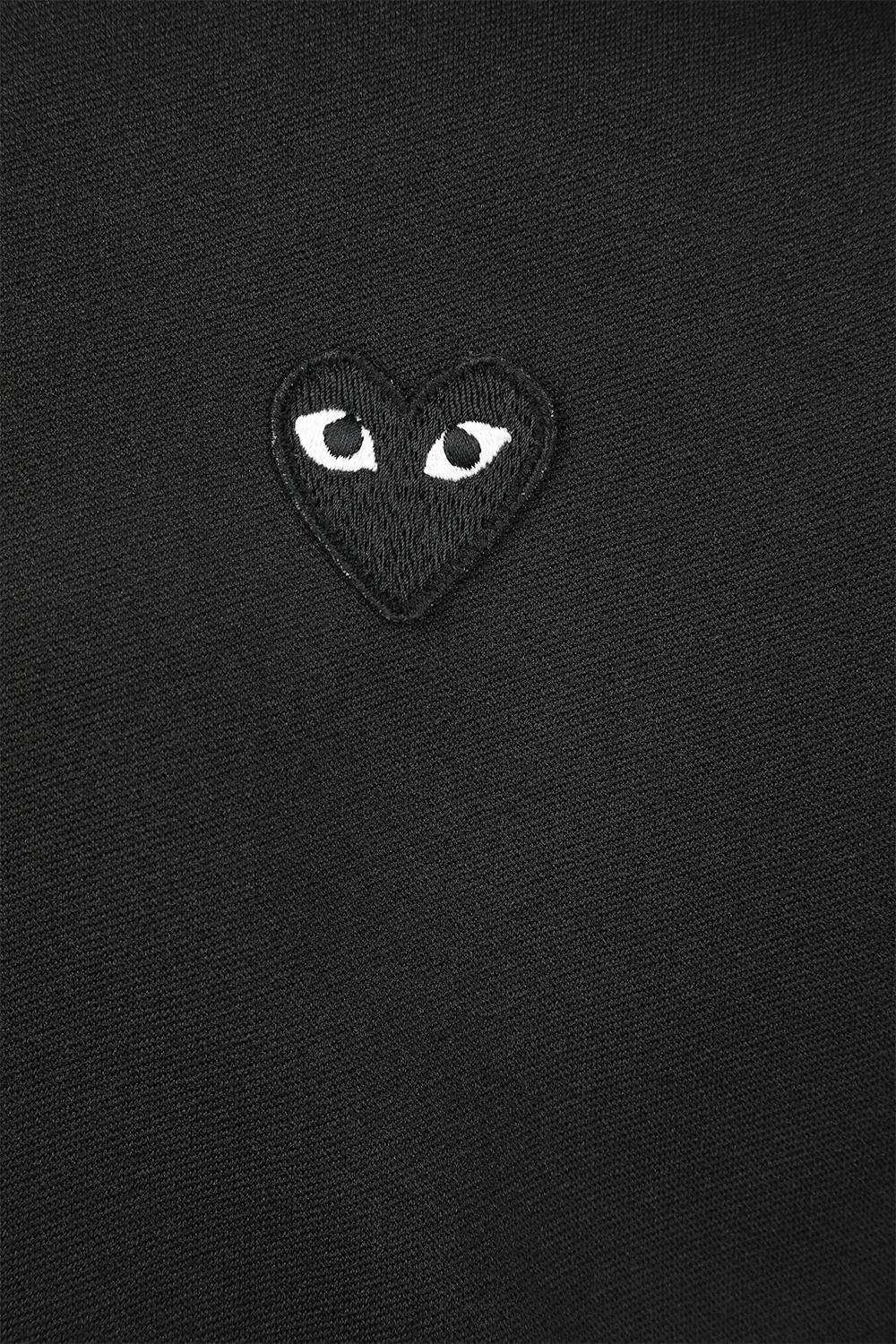 תמונת תקריב של סווטשירט שחור מרוכסן עם דוגמת לבבות