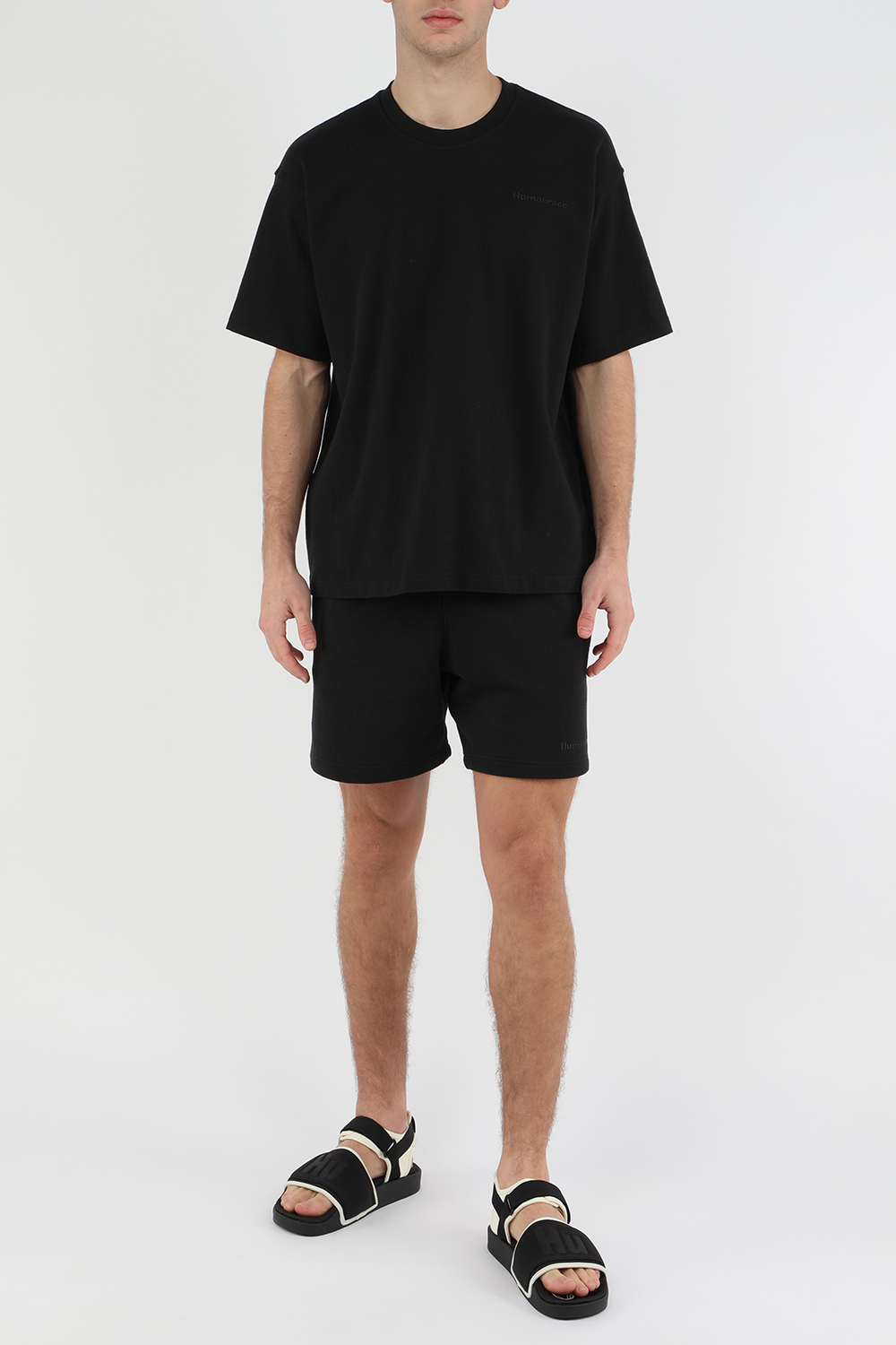 תמונת דוגמן קידמית של אדידס עם פארל וויליאמס סנדלים בצבעי שחור ולבן