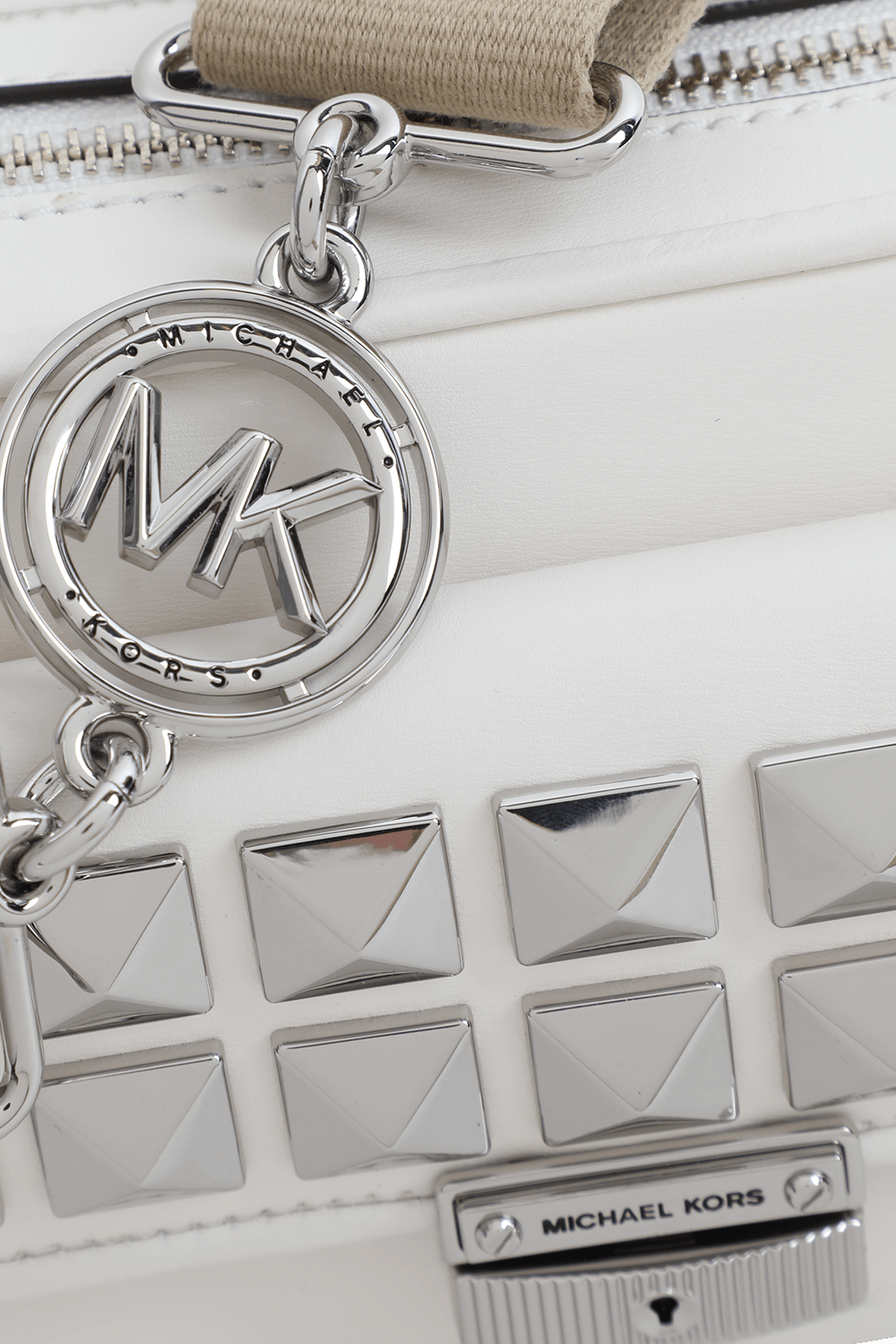 תמונת תקריב של תיק קרוס קאמרה מעור לבן עם ניטים כסופים