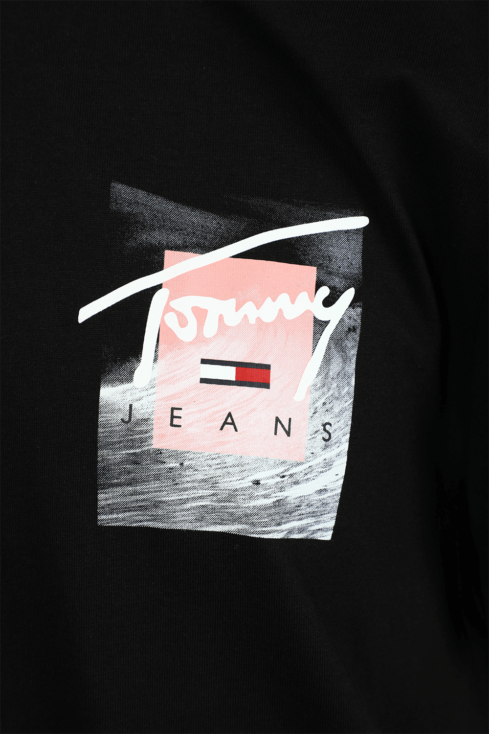 תמונת תקריב של חולצת טי שחורה עם חתימת המעצב